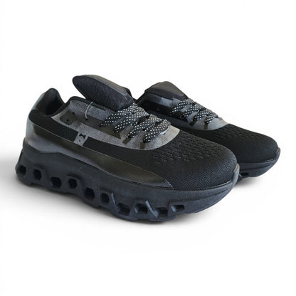 BRIKLYN black athletic running sneakers with breathable knit upper and architectural geometric midsole design.