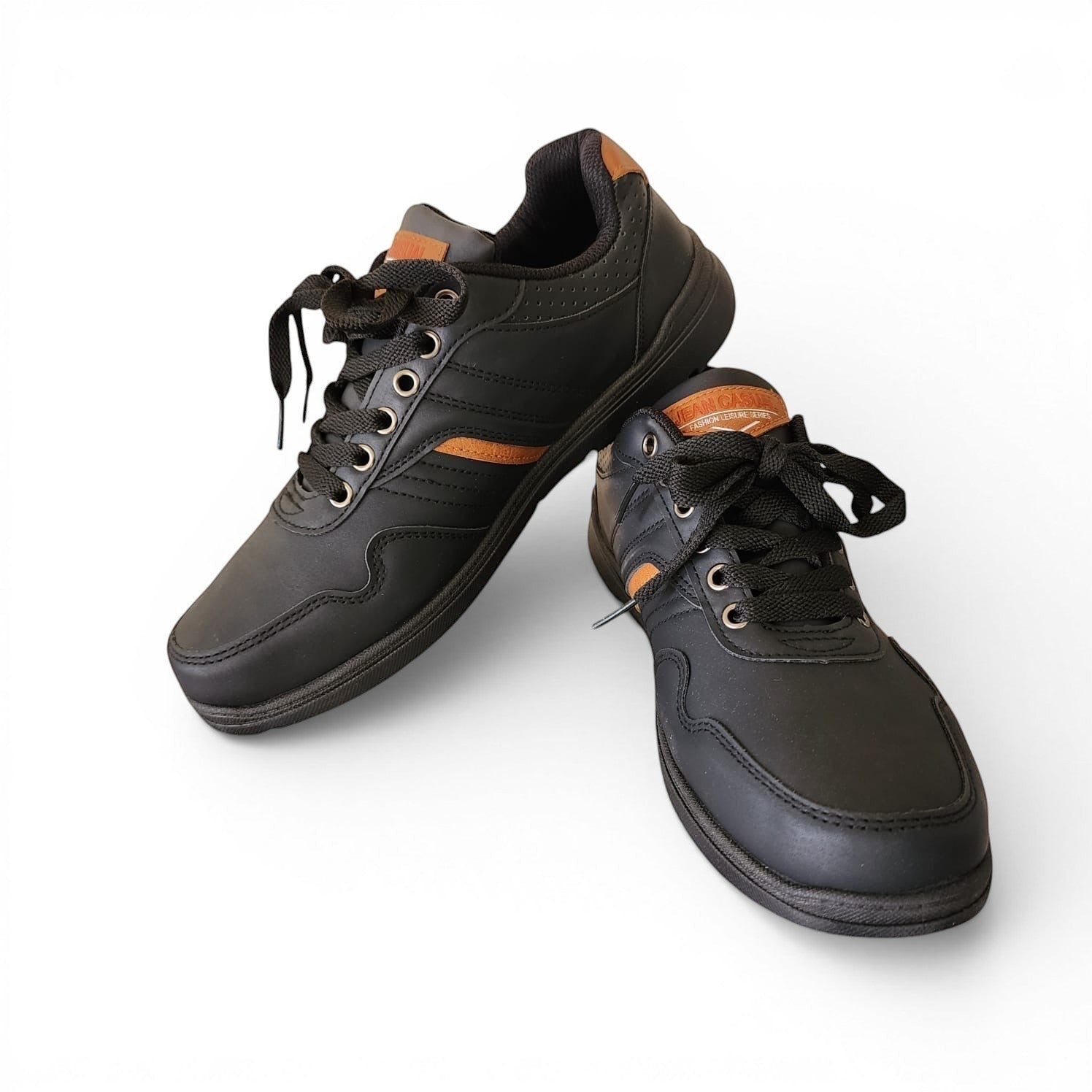 BRIKLYN black faux leather athletic sneakers with tan accents, lace-up closure, and perforated detailing.