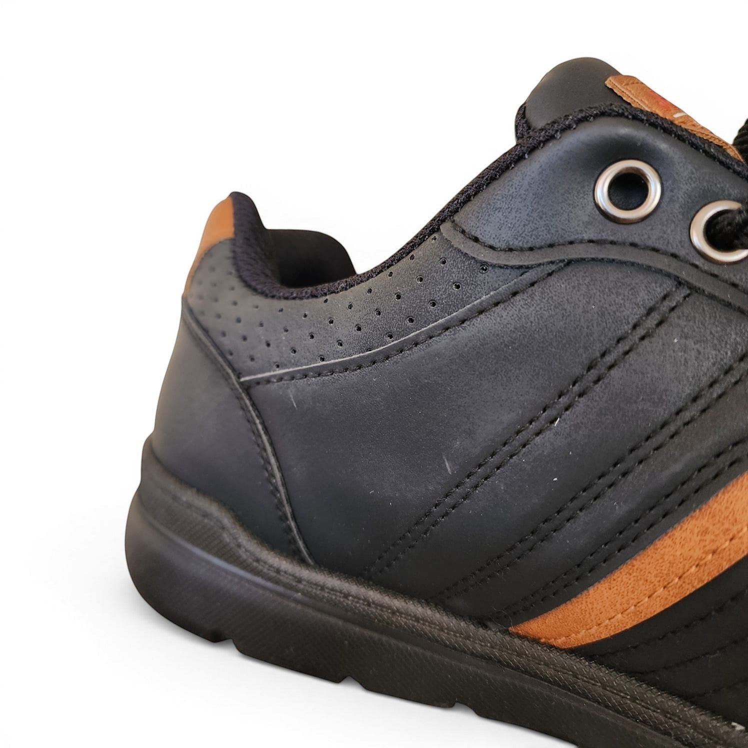 BRIKLYN black faux leather casual sneakers with tan accents, lace-up closure, and perforated detailing.