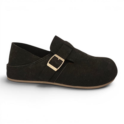 BRIKLYN black suede slip-on clog with an adjustable gold buckle strap and a flat sole for casual comfort.