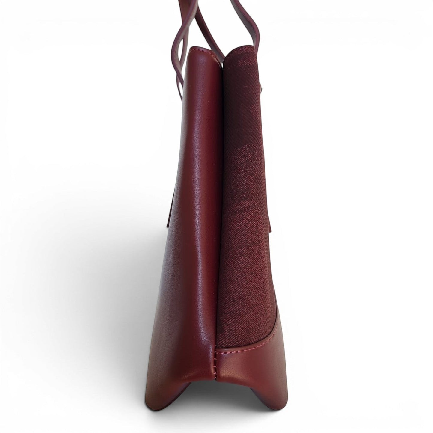 Side profile of a BRIKLYN burgundy structured tote handbag featuring smooth synthetic leather and textured panels.