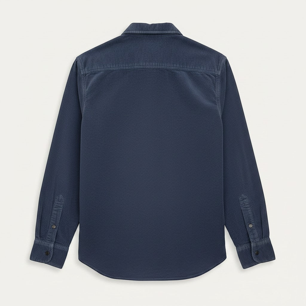 BRIKLYN navy blue corduroy long sleeve button-up shirt with two chest pockets and button cuffs.