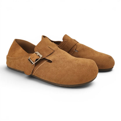 BRIKLYN tan suede slip-on clogs with an adjustable buckle strap and closed-toe design on a white background.